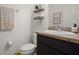 Neutral half-bathroom featuring a single sink vanity and decorative wall shelves at 141 Claire Ln, Davenport, FL 33837