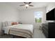 Well-lit bedroom showcasing a comfy bed, ceiling fan, and a window with bright natural light at 141 Claire Ln, Davenport, FL 33837