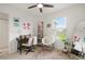 Bright room with a desk and comfortable chair, large window, and ceiling fan at 141 Claire Ln, Davenport, FL 33837
