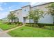 Charming townhome showcasing a well-manicured lawn and appealing landscaping, creating an inviting curb appeal at 141 Claire Ln, Davenport, FL 33837