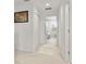 Bright hallway with access to the bedrooms, featuring fresh paint and a soft rug at 141 Claire Ln, Davenport, FL 33837