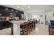 Spacious kitchen with granite countertops, stainless steel appliances, dark wood cabinetry, and a breakfast bar with seating at 141 Claire Ln, Davenport, FL 33837