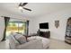 Bright living room boasts a ceiling fan and sliding glass doors with views of the backyard at 141 Claire Ln, Davenport, FL 33837