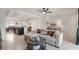 Open-concept living room leading into the kitchen and featuring tile flooring throughout at 141 Claire Ln, Davenport, FL 33837