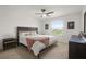 Comfortable main bedroom features a ceiling fan, bright windows, and neutral decor at 141 Claire Ln, Davenport, FL 33837