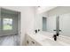 Bright bathroom featuring double sinks with quartz countertops and modern black fixtures and hardware at 15621 Sw 37Th Cir, Ocala, FL 34473