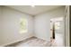 Bright bedroom with light-colored wood floors, a window letting in natural light, and a white interior door at 15621 Sw 37Th Cir, Ocala, FL 34473