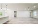 Expansive living area with modern lighting, hardwood floors, and views of the kitchen at 15621 Sw 37Th Cir, Ocala, FL 34473
