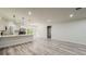 Modern open-concept living space with stainless steel appliances and hardwood floors at 15621 Sw 37Th Cir, Ocala, FL 34473