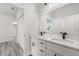 A well-lit bathroom featuring double sinks, black hardware, and a door to the hall at 16057 Sw 17Th Ave, Ocala, FL 34473