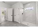 Modern bathroom with a glass-enclosed shower, marble tile, and a bright window at 16057 Sw 17Th Ave, Ocala, FL 34473