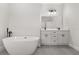 Elegant bathroom featuring a soaking tub, double vanity, and modern fixtures at 16057 Sw 17Th Ave, Ocala, FL 34473