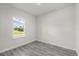 A light-filled bedroom with wood-look flooring and a view of the neighborhood at 16057 Sw 17Th Ave, Ocala, FL 34473