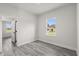 Bright bedroom features a window and gray wood-look flooring at 16057 Sw 17Th Ave, Ocala, FL 34473