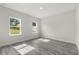 This bright bedroom features ample natural light and gray wood-look floors at 16057 Sw 17Th Ave, Ocala, FL 34473