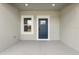 Stylish blue front door with glass panel and window on a covered porch with recessed lights enhancing curb appeal at 16057 Sw 17Th Ave, Ocala, FL 34473