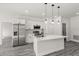Modern kitchen features stainless steel appliances and a large island with pendant lighting at 16057 Sw 17Th Ave, Ocala, FL 34473