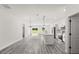 Spacious living room featuring an open floor plan, light wood flooring, and modern kitchen at 16057 Sw 17Th Ave, Ocala, FL 34473