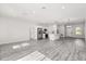 Open living space features a modern kitchen, stainless steel appliances, and sleek light gray flooring at 16057 Sw 17Th Ave, Ocala, FL 34473