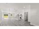 Open living space featuring an island kitchen, modern lighting, and sliding glass doors at 16057 Sw 17Th Ave, Ocala, FL 34473