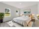 Sun-drenched main bedroom with plush bedding and large windows at 16057 Sw 17Th Ave, Ocala, FL 34473