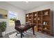 Home office features a built-in bookshelf, a desk, and a window view at 16057 Sw 17Th Ave, Ocala, FL 34473