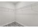 An empty walk-in closet with wire shelving and wood-look flooring is ready for customization at 16057 Sw 17Th Ave, Ocala, FL 34473