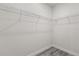 An empty walk-in closet with wire shelving and wood-look flooring is ready for customization at 16057 Sw 17Th Ave, Ocala, FL 34473