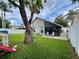 Expansive backyard with lush lawn, mature tree with a swing, and a screened lanai perfect for outdoor living at 1659 Canton Ln, Oviedo, FL 32765