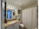 Cozy bathroom with decorative mirror, vanity and shower with patterned curtain at 1659 Canton Ln, Oviedo, FL 32765