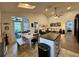 Open-concept area with kitchen island, dining table, and comfortable living area with sliding glass door to patio at 1659 Canton Ln, Oviedo, FL 32765