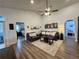 Spacious living area with vaulted ceilings, ceiling fan, wood flooring, and doorway to an adjoining bedroom at 1659 Canton Ln, Oviedo, FL 32765