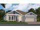 Charming single-story home with a three-car garage, landscaped yard, and blue and white exterior paint at 2287 Rider Rain Ln, Apopka, FL 32703