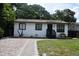 Charming single-story home with brick driveway, a cozy front yard, and a simple yet inviting facade at 233 N Hudson St, Orlando, FL 32835