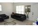 Inviting living room with tile flooring, modern furniture, a large mirror and bright, natural light at 233 N Hudson St, Orlando, FL 32835