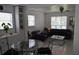 Comfortable living room featuring neutral walls, bright natural light, modern decor, and sleek tile flooring at 233 N Hudson St, Orlando, FL 32835