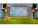 Aerial view of screened in pool with lounge chairs and landscaping at 2850 Bookmark Dr, Kissimmee, FL 34746