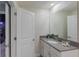 Modern bathroom featuring a stylish sink with a gray quartz countertop and a mirrored cabinet, combining style and function at 2850 Bookmark Dr, Kissimmee, FL 34746