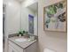 Bathroom featuring a vanity with modern fixtures and a decorative mirror at 2850 Bookmark Dr, Kissimmee, FL 34746