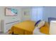 Bright bedroom with modern decor, beach artwork, and a large window at 2850 Bookmark Dr, Kissimmee, FL 34746