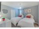 Well-lit bedroom features twin beds, closet, chandelier, and tasteful decor at 2850 Bookmark Dr, Kissimmee, FL 34746