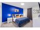 A charming bedroom is adorned with a striking blue accent wall, complemented by soft gray carpet and elegant decor at 2850 Bookmark Dr, Kissimmee, FL 34746