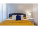 Cozy bedroom with geometric wallpaper, modern furniture, and bright bedding at 2850 Bookmark Dr, Kissimmee, FL 34746