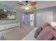Charming bedroom boasting a ceiling fan, tv, and en-suite bath with a door that provides easy access and privacy at 2850 Bookmark Dr, Kissimmee, FL 34746