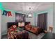 Themed bedroom with twin beds, decorative wall art, lighting, and a unique atmosphere at 2850 Bookmark Dr, Kissimmee, FL 34746