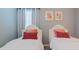 Bedroom features two twin beds with decorative pillows, and a bright window at 2850 Bookmark Dr, Kissimmee, FL 34746