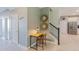 Bright entryway with stylish decor, a cozy workspace, and a view into the kitchen, creating an inviting first impression at 2850 Bookmark Dr, Kissimmee, FL 34746
