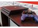 Close-up of a PlayStation 4 Pro console with a controller on a shelf at 2850 Bookmark Dr, Kissimmee, FL 34746