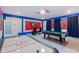 Spacious game room with an air hockey table, pool table, and themed decor for entertainment at 2850 Bookmark Dr, Kissimmee, FL 34746