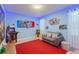 Colorful game room with arcade games, a comfortable couch, and playful Mario-themed decor at 2850 Bookmark Dr, Kissimmee, FL 34746